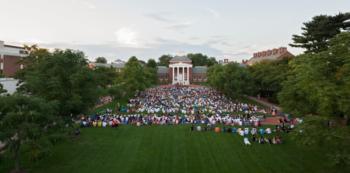 a crowd gathering on a university lawn