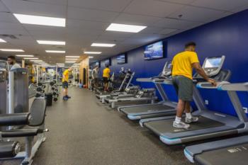 man using treadmill in campus gym