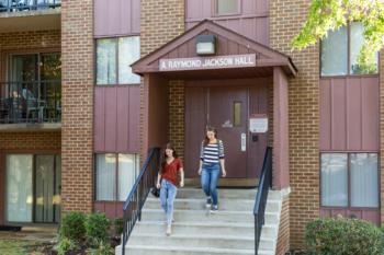 two students exiting 'a. raymond jackson hall'