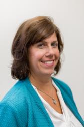 portrait of a smiling woman in blue cardigan