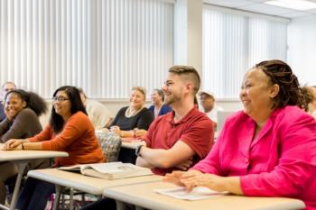 diverse group of students smiling in class