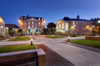 campus buildings lit up at dusk