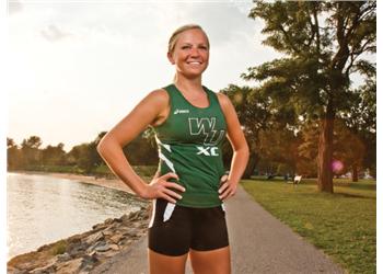 female athlete standing by the water