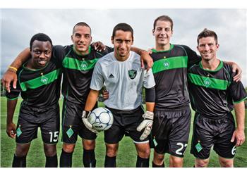 soccer team posing with a ball