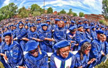 crowd of graduates in blue gowns