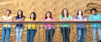 seven women on a balcony in casual wear