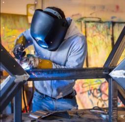 student welding in a studio