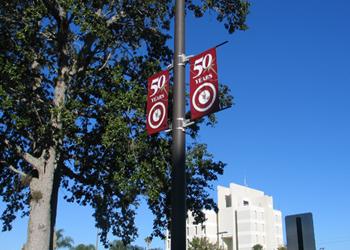 anniversary banners on light post under blue sky