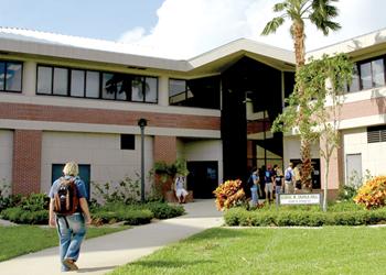 students entering building with 'library' sign