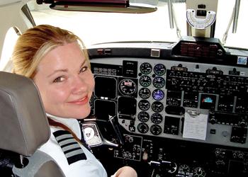 pilot smiling in cockpit with controls