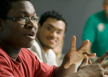 focused student in a class raising hand