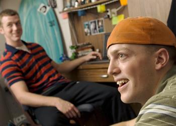 two students in casual chat in a dorm room