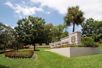 entrance sign and building behind trees