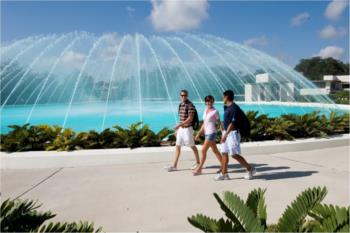 three people by a fountain