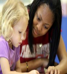 young child and teacher with crafts