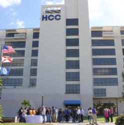 building with 'hcc' logo and students gathered outside