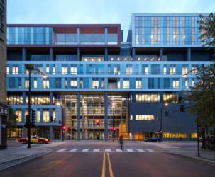 modern building facade with lit interior at twilight