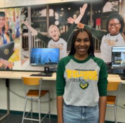 student smiling in campus library