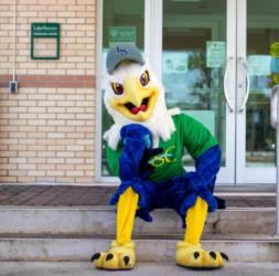 mascot in front of 'lake-sumter state college' entrance