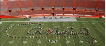 marching band on field forming 'Canes' text