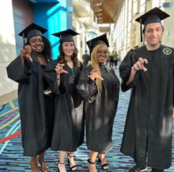 graduates smiling and posing at commencement