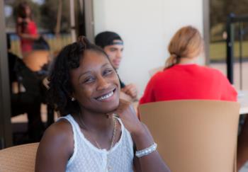 smiling student sitting at a table