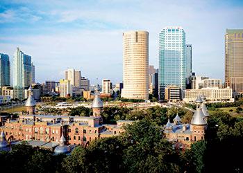 campus buildings with downtown skyline in background