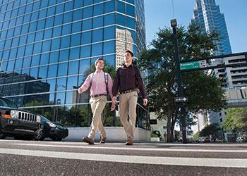 two interns walking in a downtown city