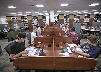 students studying in a library with computers