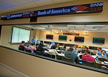 students in a trading center with screens