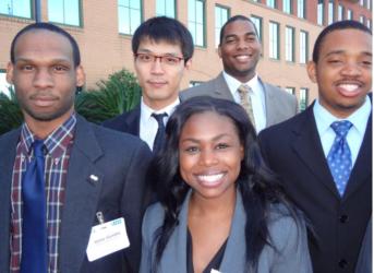 group of smiling students in business attire