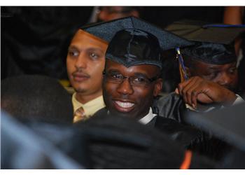 smiling graduate in cap and gown