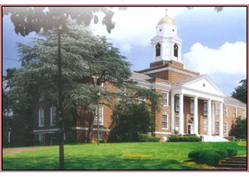 church-like building with a clock tower and columns