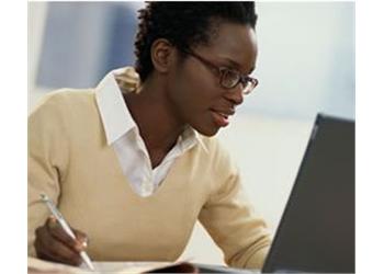 woman studying intently at a laptop