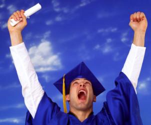 graduate in cap and gown cheering with diploma