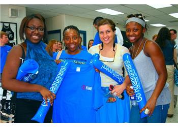 students holding promotional material