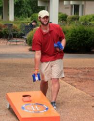 man playing cornhole on campus