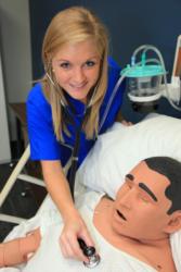 nursing student practices on a mannequin