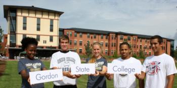 students holding signs spelling 'gordon state college'