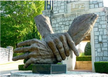 sculpture of two giant hands shaking