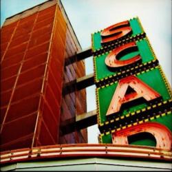 close-up of lit 'SCAD' sign on building facade