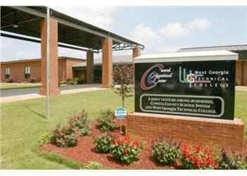 college signboard with flowers and a covered walkway