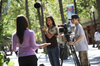 students filming with camera and boom