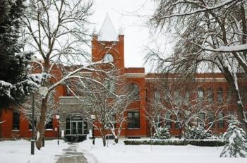 brick building with clock tower in snow