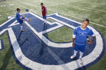 students on field with large 'A' logo