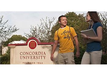 students by 'concordia university' sign