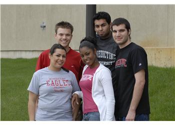 five students posing together smiling