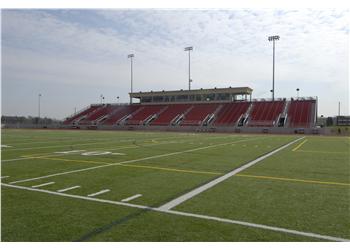 football field and stadium with red seating