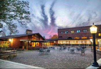 campus building at dusk with dramatic sky and outdoor seating