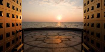 sunset view from a balcony with architectural details